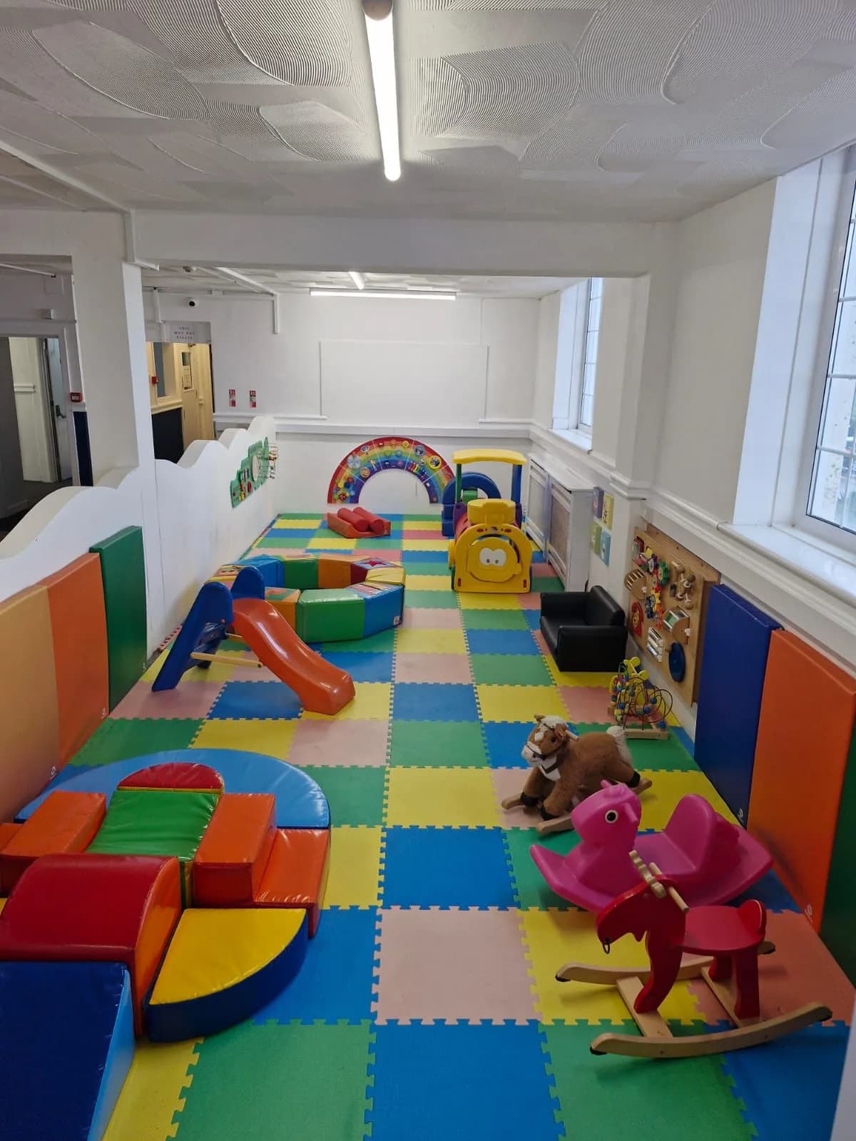 The under-2s room with soft shapes on a bright play mat